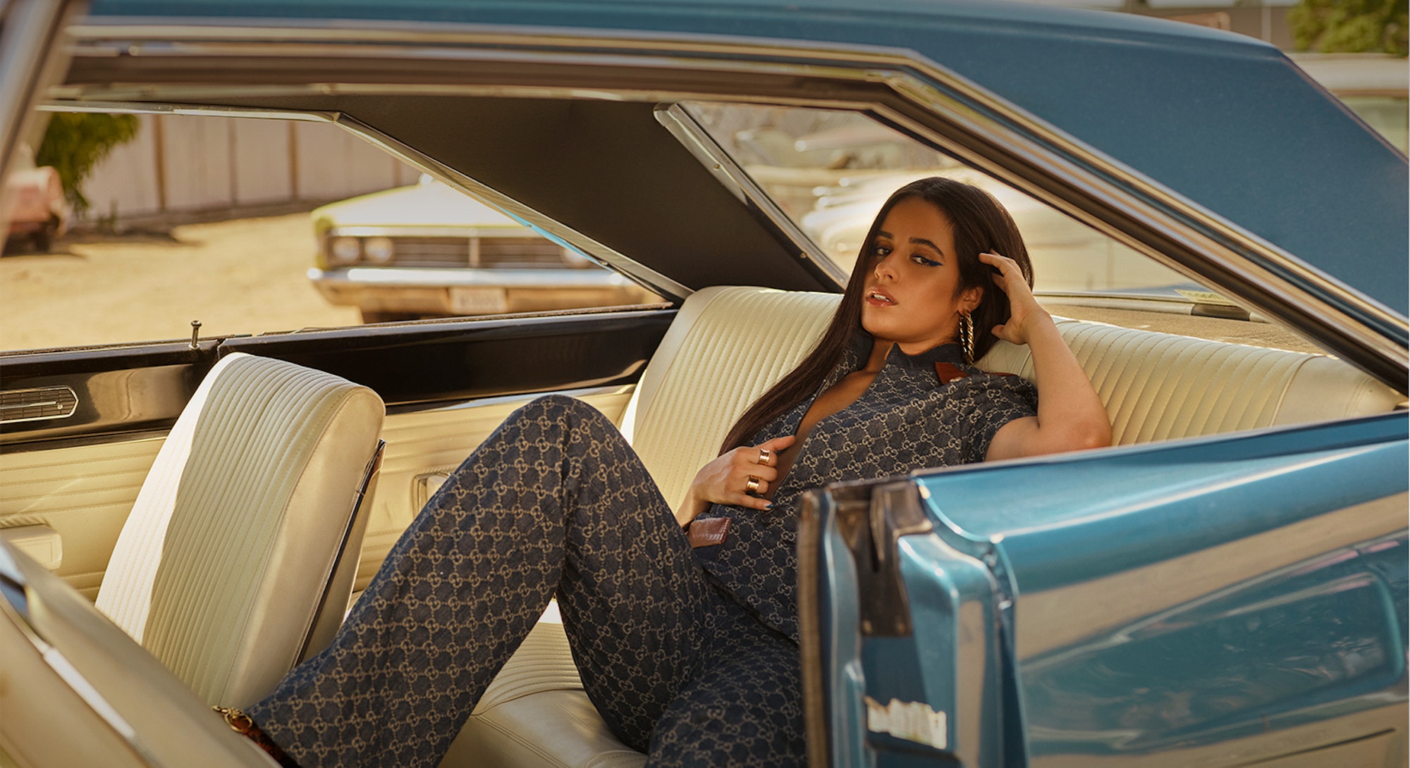 Camila Cabello wears denim Gucci while posing in a car for the cover of Bustle's denim issue.