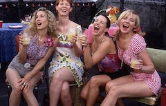 Carrie, Samantha, Charlotte, and Miranda from "Sex and the City"  having a drink together