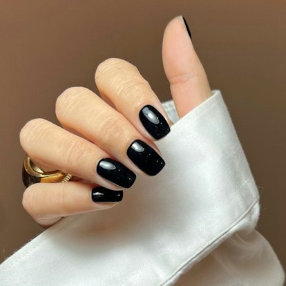 One of the most popular winter nail polish color trends for 2024 is glossy black.